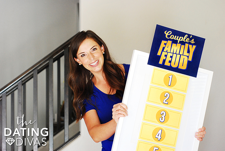 A woman holding a DIY Family Feud game | The Dating Divas